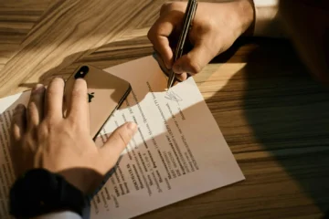 person writing on white paper