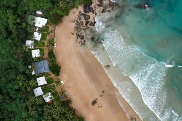 Aerial view of beachfront bungalows on the sand within Mexico's federal maritime zone (ZOFEMAT)